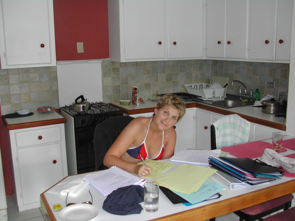 Cynthia grading papers in tobago
